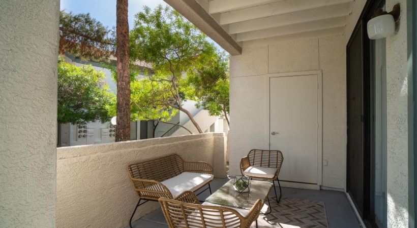 a patio with a table and chairs