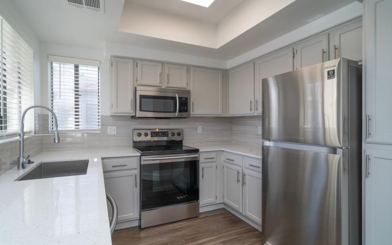 a kitchen with white cabinets