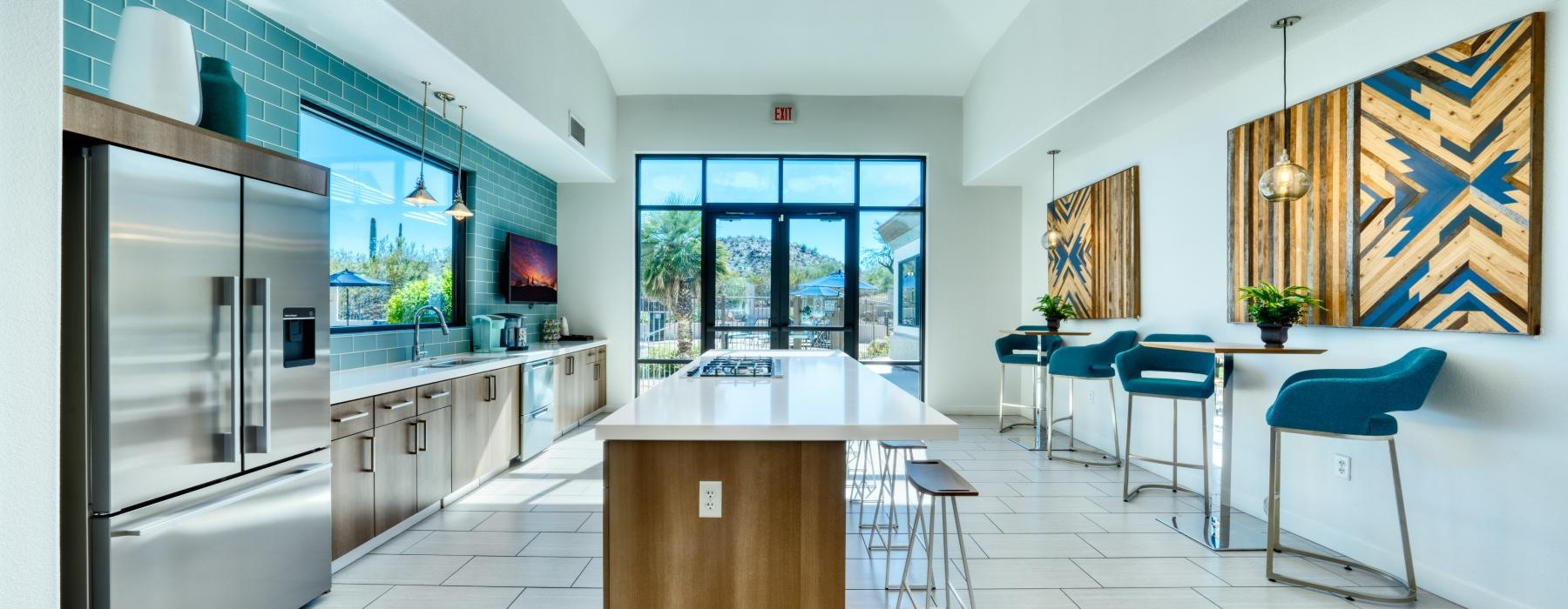 a kitchen with a bar and chairs