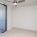 a room with a ceiling fan and glass doors