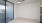 a room with a ceiling fan and glass doors