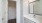 a bathroom with white cabinets
