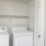 a white kitchen with a washer and dryer