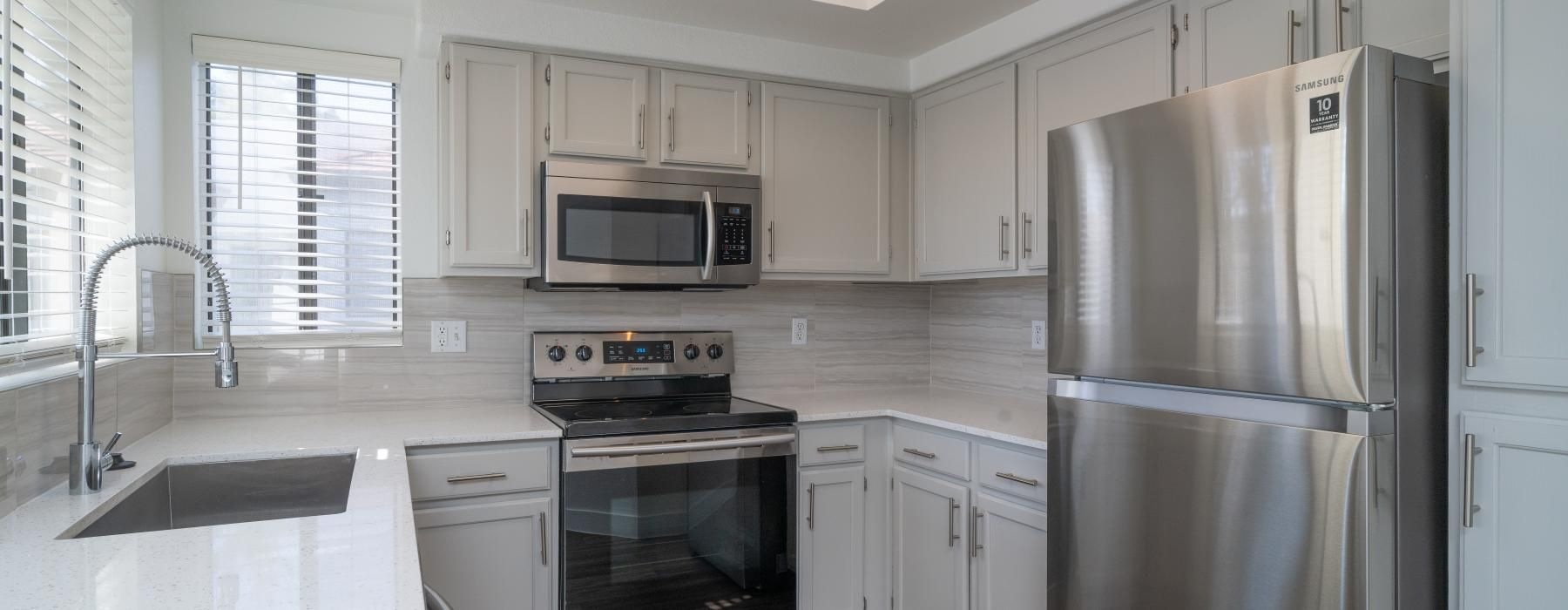 a kitchen with white cabinets