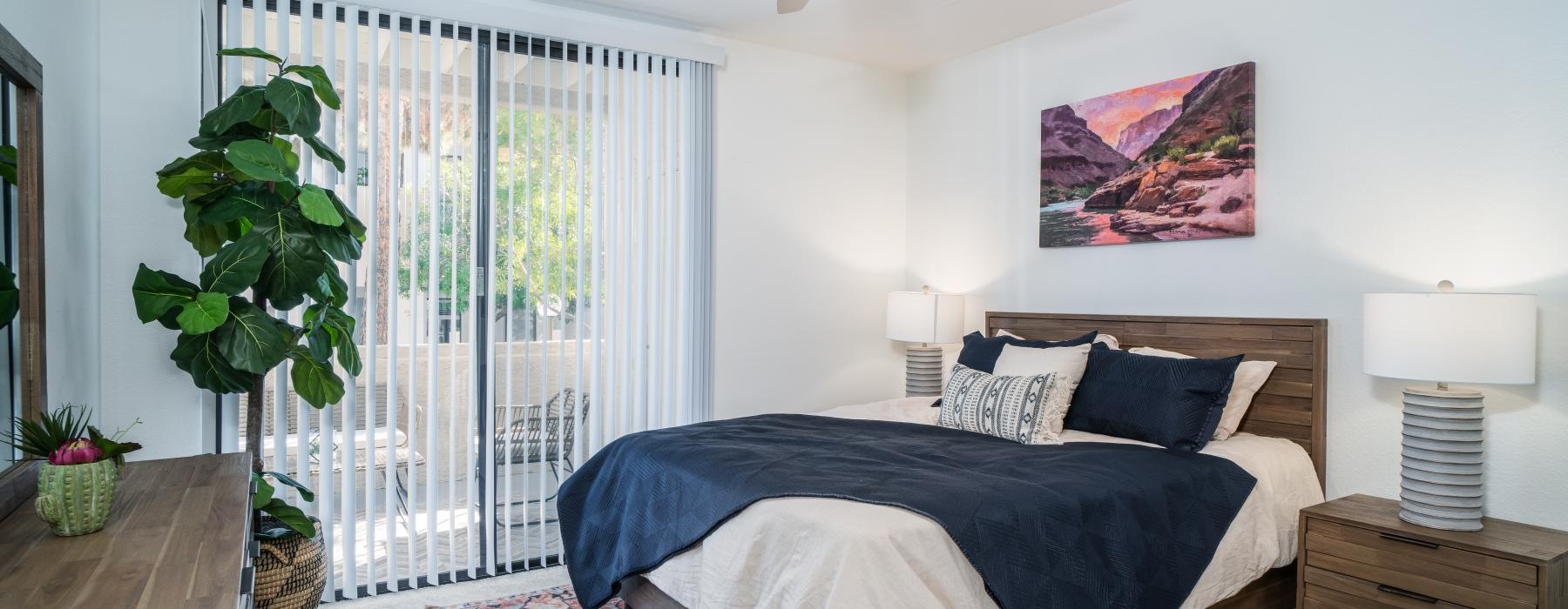 a bedroom with a bed and a fan