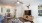 a living room with a ceiling fan and a table