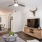 a living room with a ceiling fan and a table