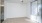 a room with a white wall and a ceiling fan