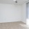 a room with a white wall and a ceiling fan