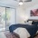 a bedroom with a bed and a fan
